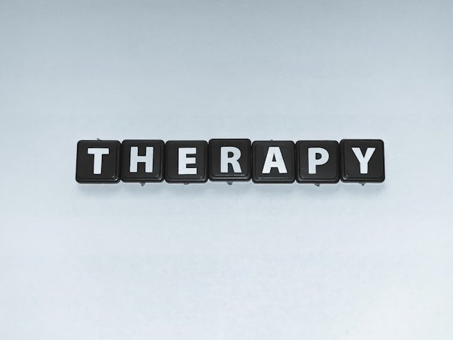 Person speaking with a therapist during a session focused on positive emotions and emotional wellbeing