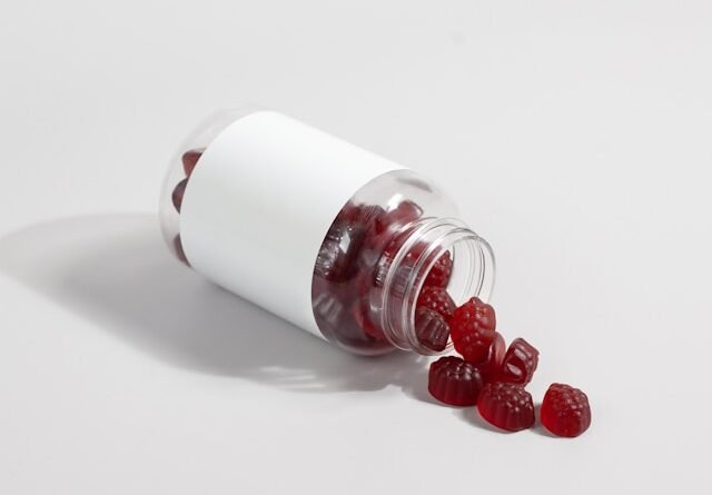 Ashwagandha root and standardized supplement capsules beside a cup of herbal tea