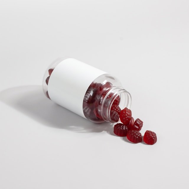 Ashwagandha root and standardized supplement capsules beside a cup of herbal tea