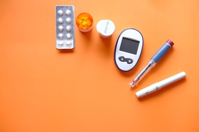 Older adult checking blood glucose with a glucose monitor while reviewing Medicare diabetes coverage and medication costs.