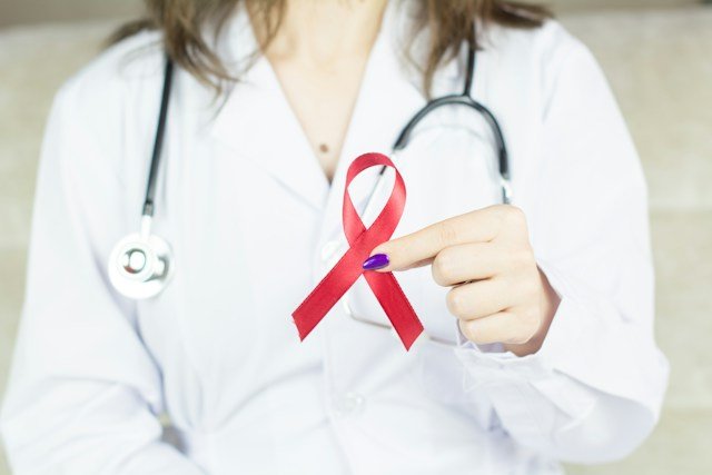 Healthcare professional discussing a blood-based ESR1 mutation test with a breast cancer patient in a modern oncology clinic