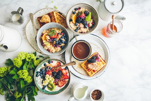 Healthy high protein breakfast spread featuring cottage cheese, eggs, and fresh whole foods on a rustic table