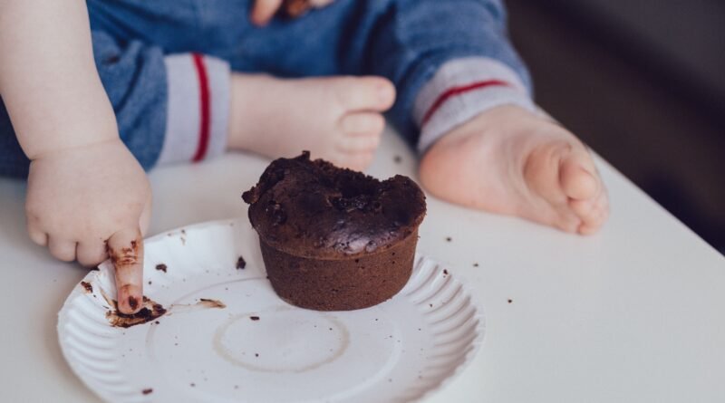 Parent preparing nutritious low-sugar food for a young child during early development