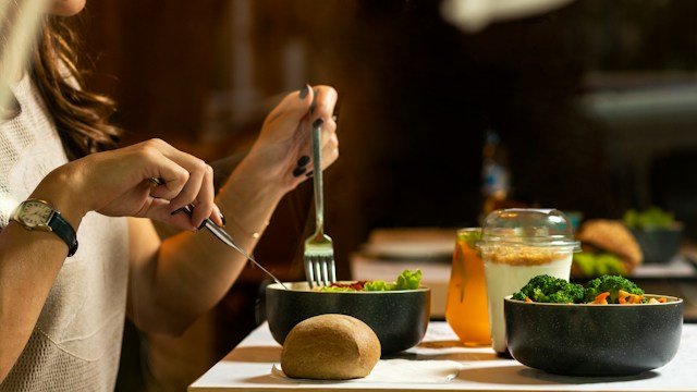 An adult considering a balanced meal while reflecting on changes in appetite and eating habits