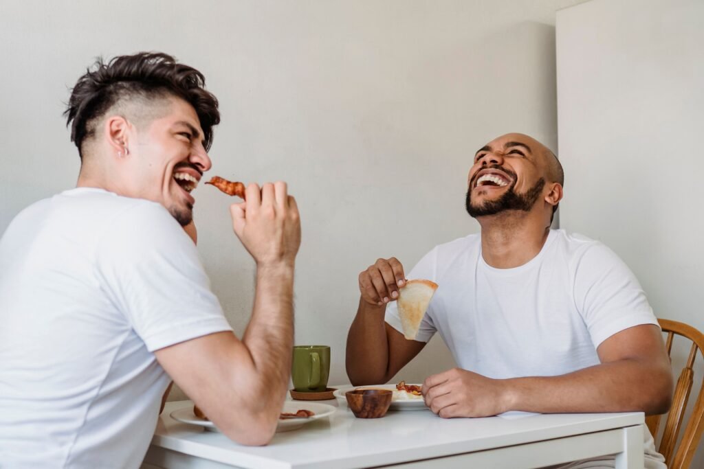 Friends sharing a genuine laugh, illustrating the potential connection between social connection, stress relief and heart health.