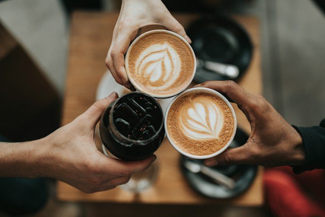 Freshly brewed coffee beside a scientific illustration representing how caffeine affects the brain and body
