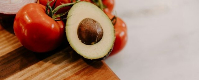 Colorful vegetables, fruits, whole grains, legumes, nuts and protein-rich foods arranged as a balanced healthy meal